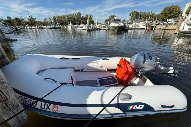 Slide: The Image of Inflatable boat with Honda motor docked near Sea Ray 360 Sundancer, 2002 model, in marina. - 31