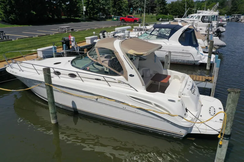 Slide: The Image of 2002 Sea Ray 360 Sundancer docked at marina, featuring sleek design and spacious deck. - 5