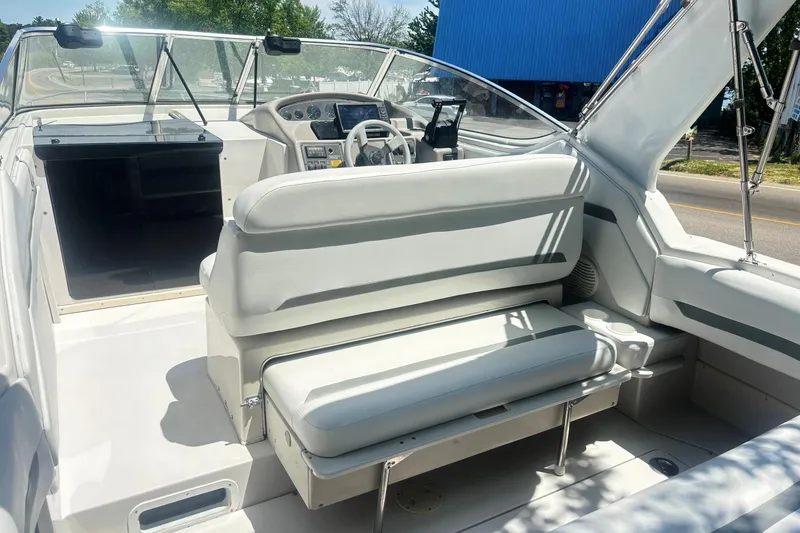 Slide: The Image of 1994 Four Winns 278 Vista boat interior with white seating and steering console. - 10