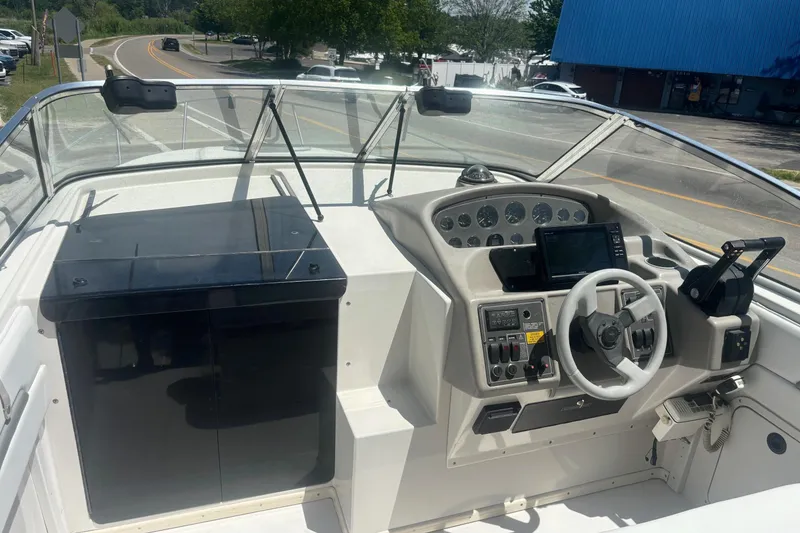 Slide: The Image of 1994 Four Winns 278 Vista boat cockpit with steering wheel and control panel. - 13