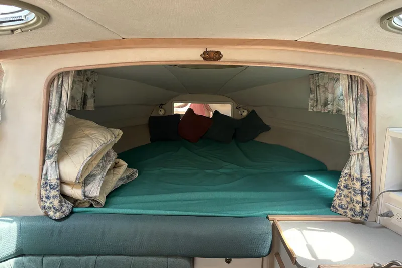 Slide: The Image of Cozy cabin interior of 1994 Four Winns 278 Vista boat with teal bedding and floral curtains. - 18