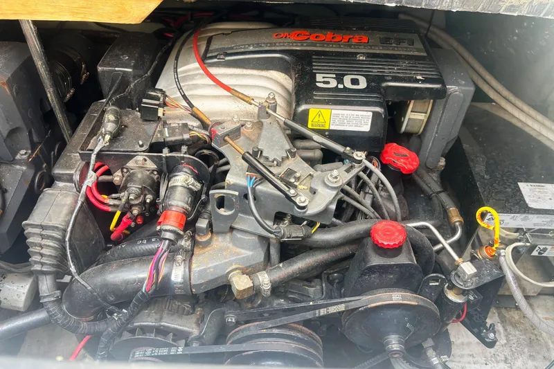 Slide: The Image of Engine of a 1994 Four Winns 278 Vista boat, featuring OMC Cobra 5.0 EFI. - 24