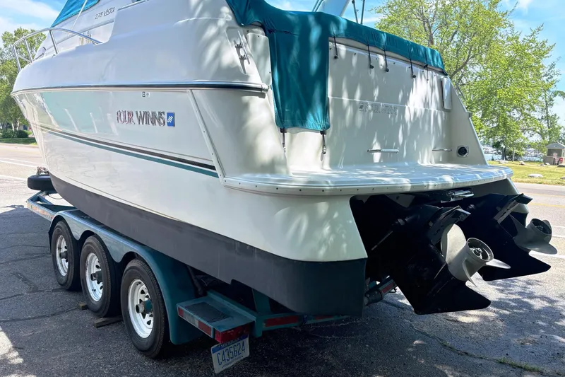 Slide: The Image of 1994 Four Winns 278 Vista boat on trailer, rear view with dual propellers. - 5