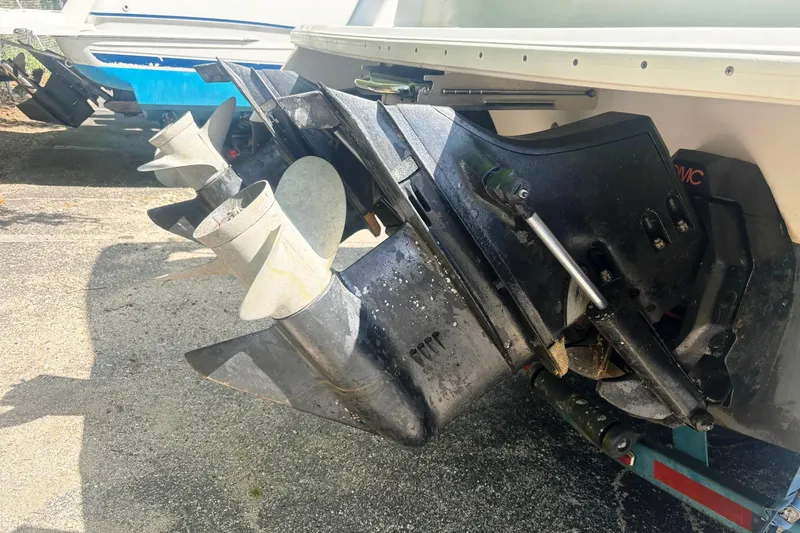 Slide: The Image of 1994 Four Winns 278 Vista boat with dual propellers and outdrive, parked on a trailer. - 6