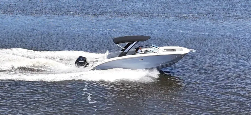 Slide: The Image of 2027 Sea Ray SDX 290 Outboard cruising on calm waters. - 20
