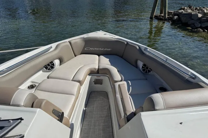 Slide: The Image of 2022 Crownline 265 SS boat interior with cushioned seating and water view. - 5