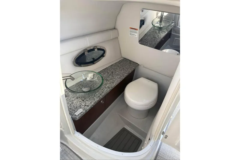 Slide: The Image of 2022 Crownline 265 SS boat bathroom with granite countertop and modern fixtures. - 7