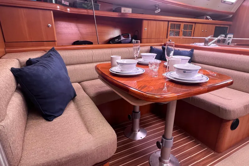 Slide: The Image of Interior of a 2006 Hunter 38 yacht with a set dining table. - 1