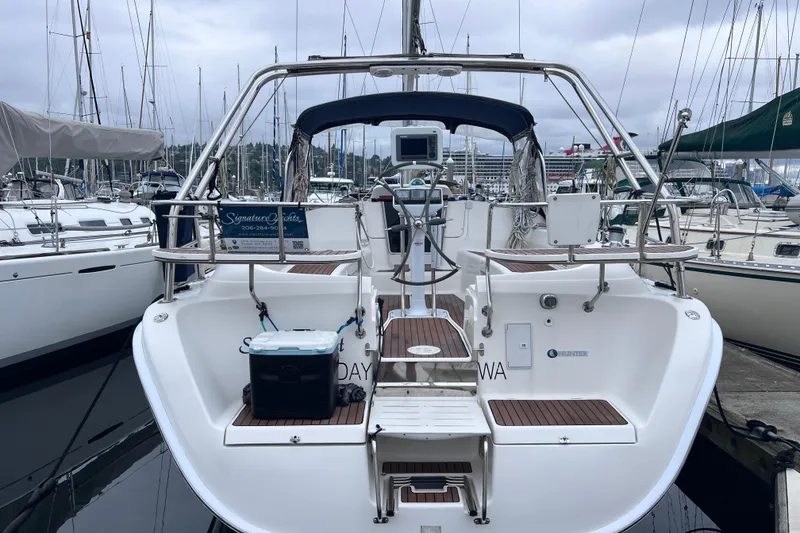 Slide: The Image of Rear view of a 2006 Hunter 38 sailboat docked in marina. - 2