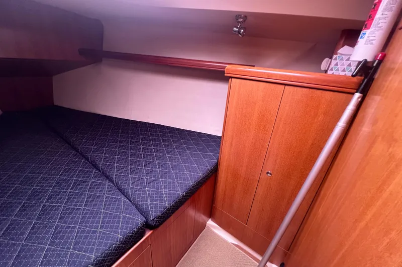 Slide: The Image of Interior of a 2006 Hunter 38 yacht with wooden furnishings and sleeping area. - 22