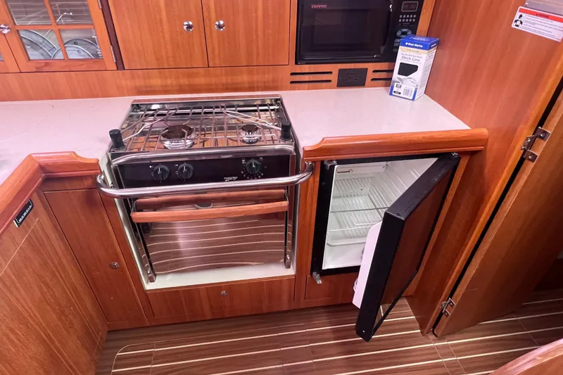 Slide: The Image of 2006 Hunter 38 yacht kitchen area with stove and fridge. - 26