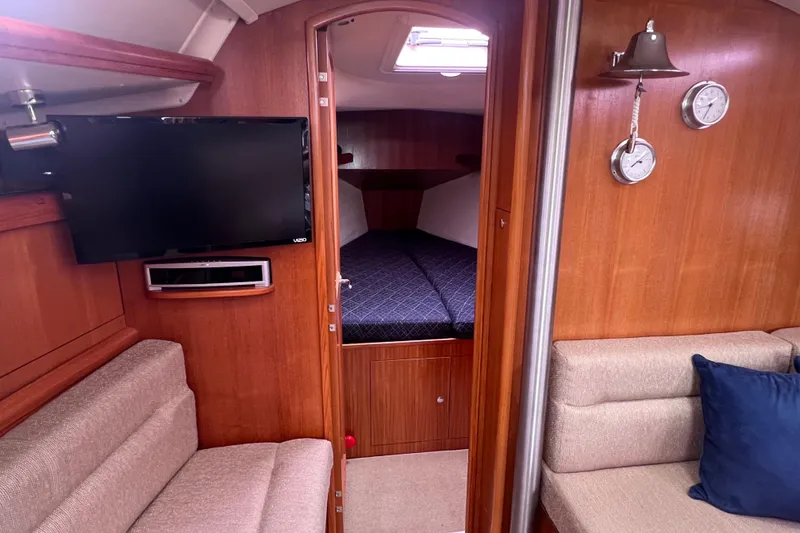 Slide: The Image of Interior of a 2006 Hunter 38 yacht with TV and sleeping area. - 29