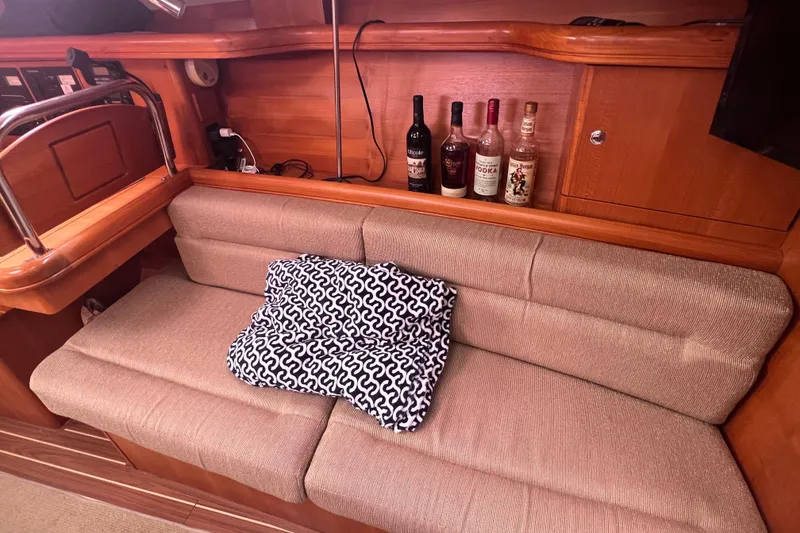 Slide: The Image of Interior of a 2006 Hunter 38 yacht with sofa and spirits. - 30