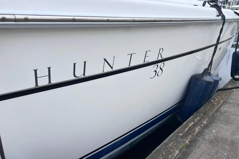 Slide: The Image of Side view of a 2006 Hunter 38 yacht docked. - 34