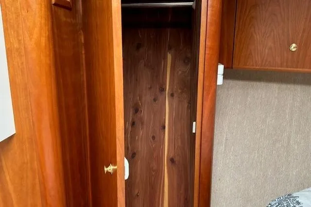 Slide: The Image of Wooden closet interior on a 2000 Silverton 41 Convertible boat. - 17