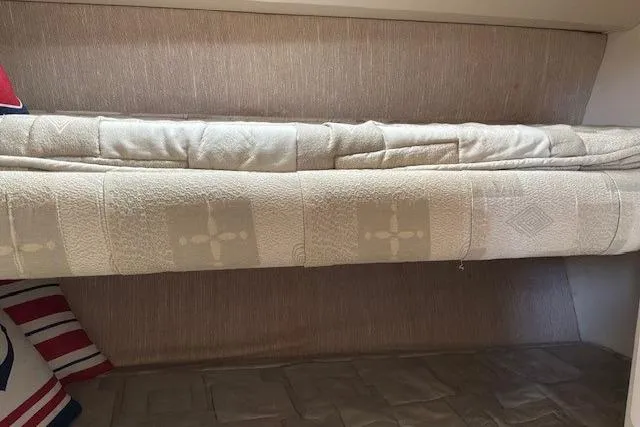 Slide: The Image of Interior cabin of 2000 Silverton 41 Convertible with bunk beds and nautical-themed pillows. - 19
