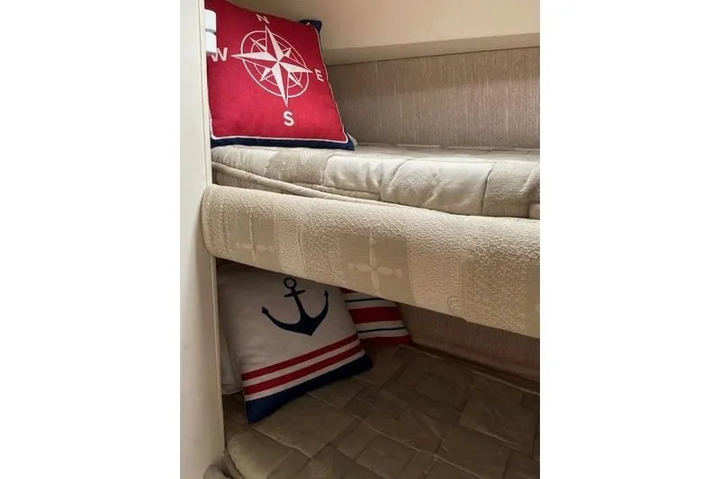 Slide: The Image of Interior of 2000 Silverton 41 Convertible with nautical-themed pillows on a bunk bed. - 20
