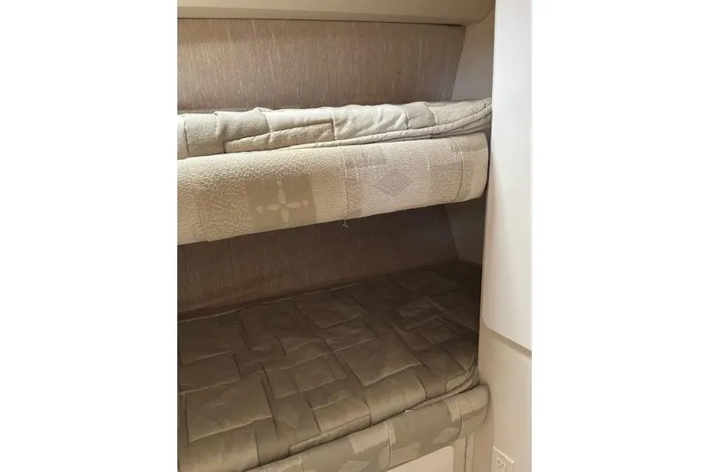 Slide: The Image of Bunk beds inside a 2000 Silverton 41 Convertible yacht cabin. - 21