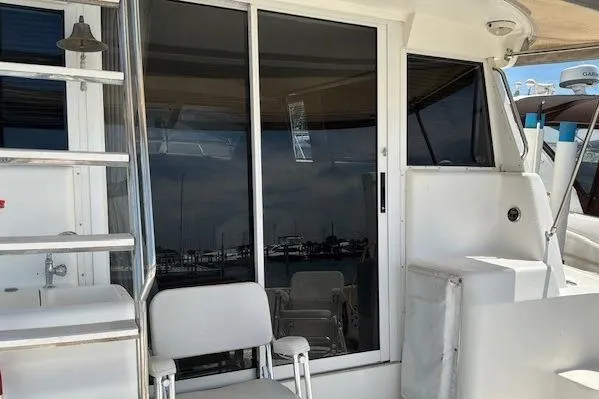 Slide: The Image of Silverton 41 Convertible 2000 yacht with sliding glass doors and outdoor seating. - 28