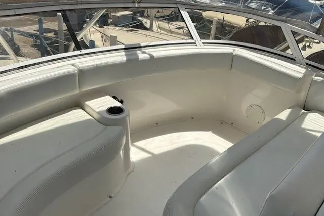 Slide: The Image of Interior seating area of a 2000 Silverton 41 Convertible boat with white upholstery. - 29
