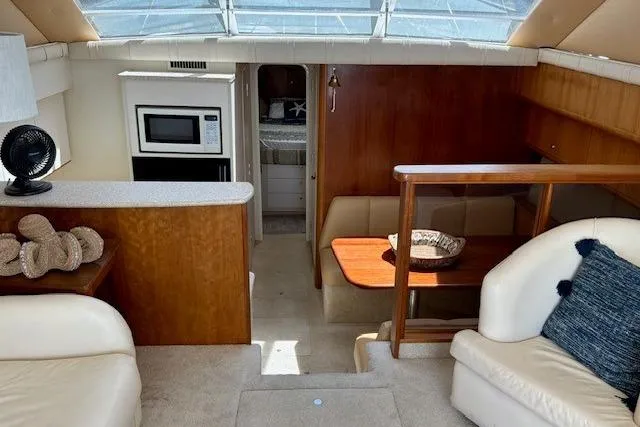 Slide: The Image of Interior of 2000 Silverton 41 Convertible yacht with kitchen and seating area. - 3