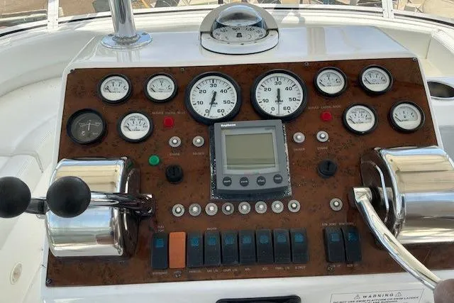 Slide: The Image of Control panel of a 2000 Silverton 41 Convertible boat with gauges and switches. - 31