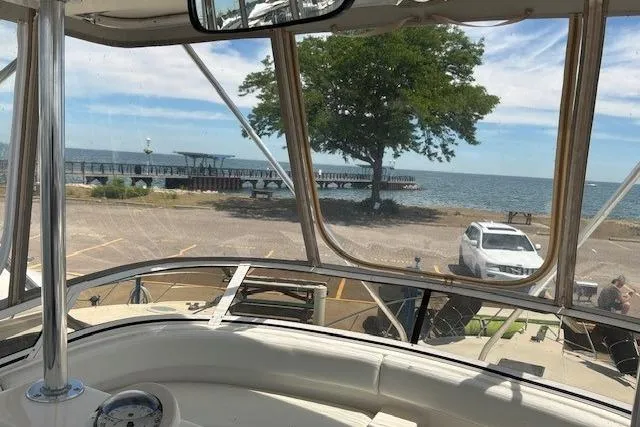 Slide: The Image of View from a 2000 Silverton 41 Convertible boat overlooking a scenic lakeside dock. - 35