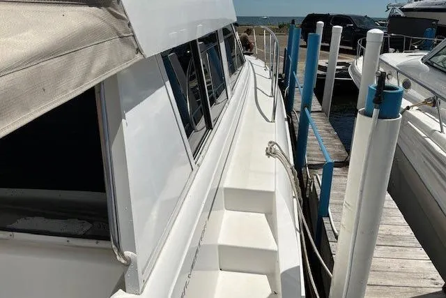 Slide: The Image of 2000 Silverton 41 Convertible yacht docked at marina, side view. - 37