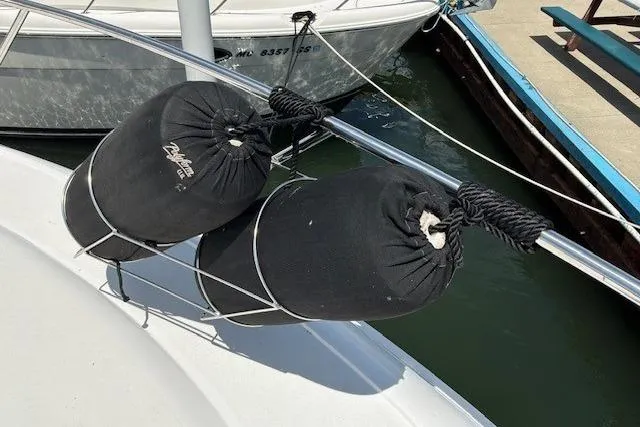 Slide: The Image of Fenders on a 2000 Silverton 41 Convertible boat docked at a marina. - 39
