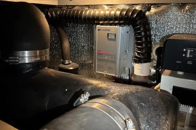 Slide: The Image of Engine room of a 2000 Silverton 41 Convertible boat, featuring mechanical components and wiring. - 41