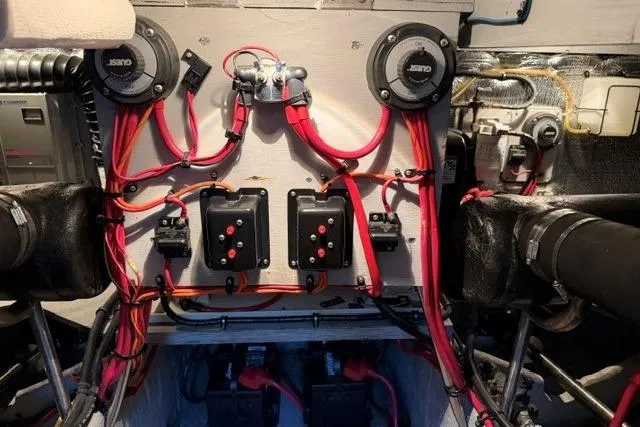 Slide: The Image of Engine room wiring of a 2000 Silverton 41 Convertible boat, featuring red cables and electrical components. - 42