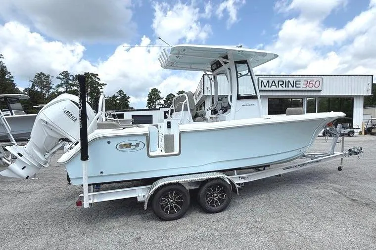 The Image of 2026 Sea Hunt Ultra 235 SE boat on trailer under cloudy sky at Marine 360 dealership. - 0