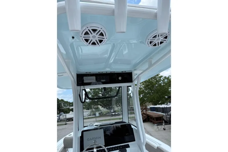 Slide: The Image of 2026 Sea Hunt Ultra 235 SE boat interior with Garmin navigation system and overhead speakers. - 11