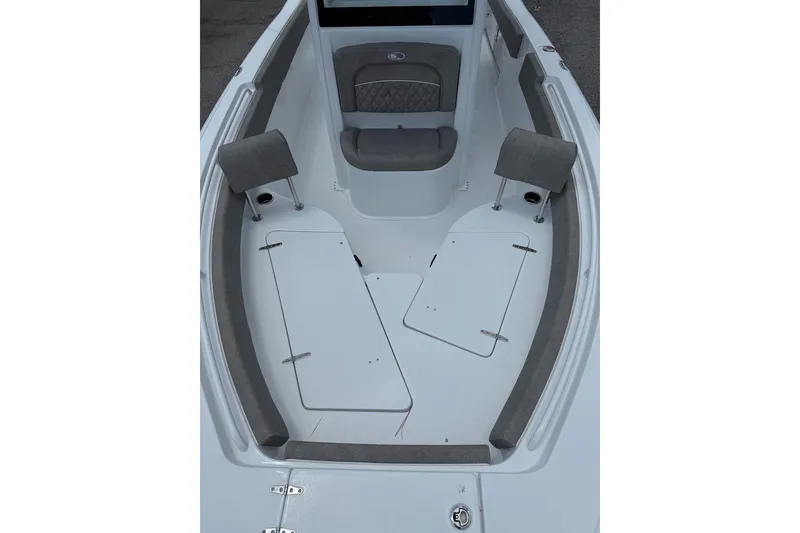 Slide: The Image of 2026 Sea Hunt Ultra 235 SE boat interior with cushioned seating and storage compartments. - 13