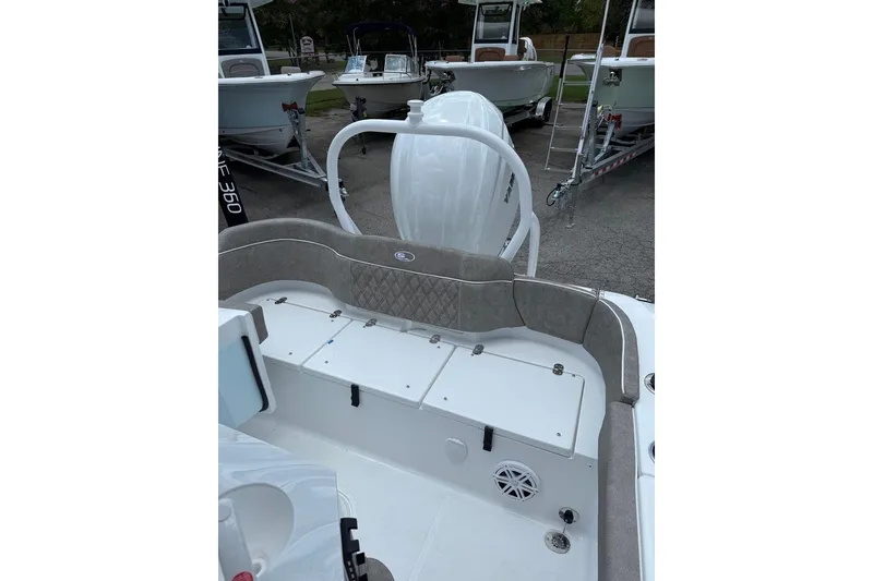 Slide: The Image of 2026 Sea Hunt Ultra 235 SE boat interior with cushioned seating and storage compartments. - 6