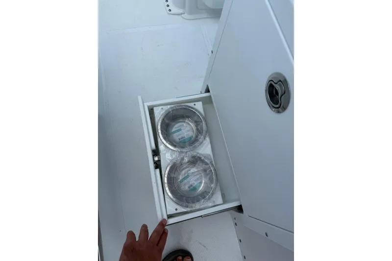 Slide: The Image of Storage drawer with two metal bowls on Sea Hunt Ultra 235 SE boat, 2026 model. - 8