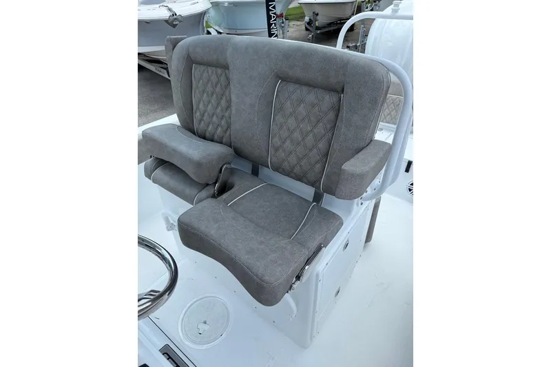 Slide: The Image of 2026 Sea Hunt Ultra 235 SE boat seat with gray upholstery and diamond stitching. - 9