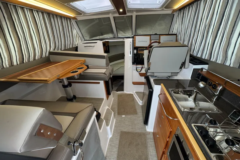 Slide: The Image of Interior of 2025 Cutwater C-288 Coupe featuring modern kitchen and seating area. - 10