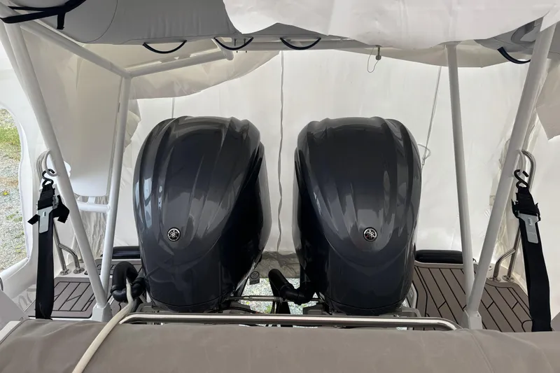 Slide: The Image of Twin Yamaha outboard engines on a 2025 Cutwater C-288 Coupe boat, under a protective canopy. - 2