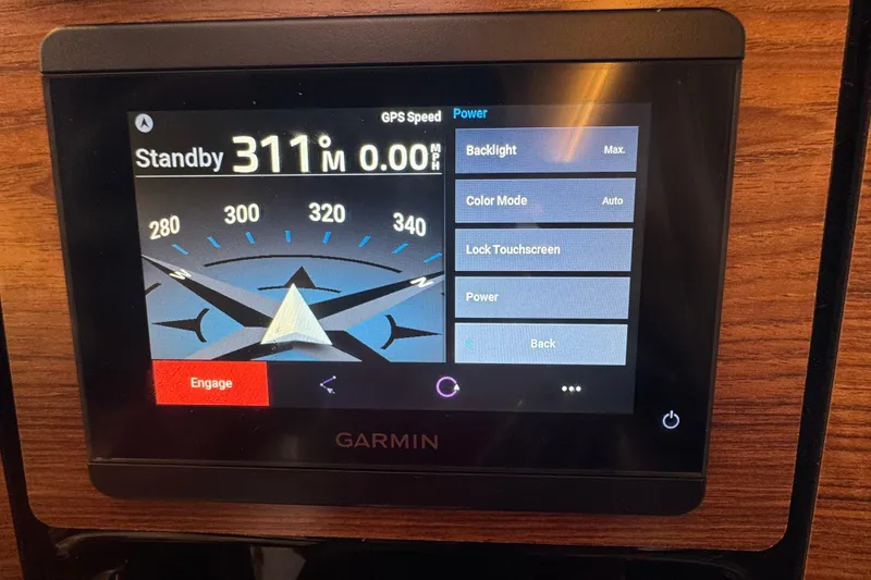 Slide: The Image of Garmin navigation display on 2025 Cutwater C-288 Coupe, showing compass and settings menu. - 3