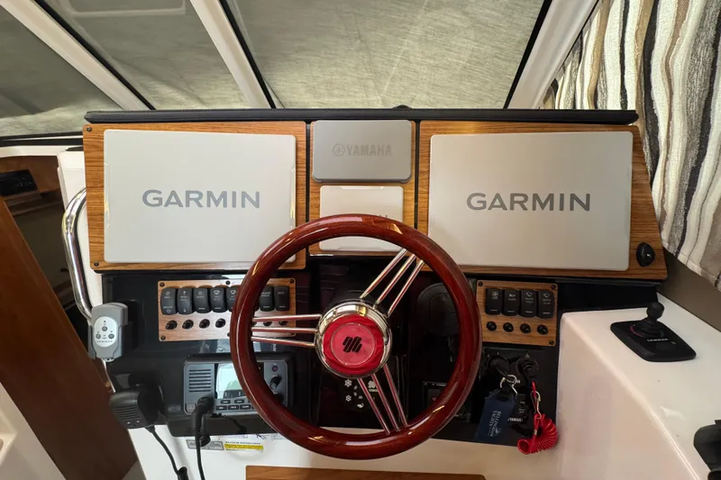 Slide: The Image of Helm of 2025 Cutwater C-288 Coupe with Garmin displays and Yamaha controls. - 7