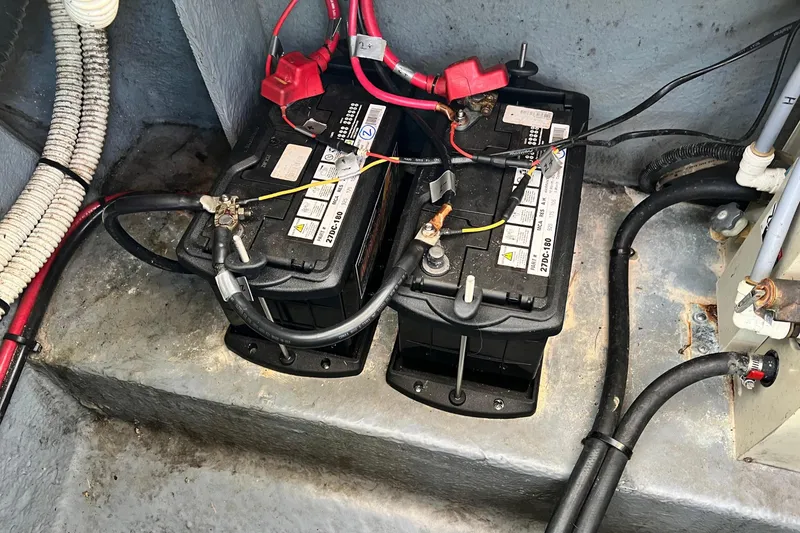 Slide: The Image of Batteries in the engine compartment of a 1996 Sea Ray 270 Sundancer boat. - 12