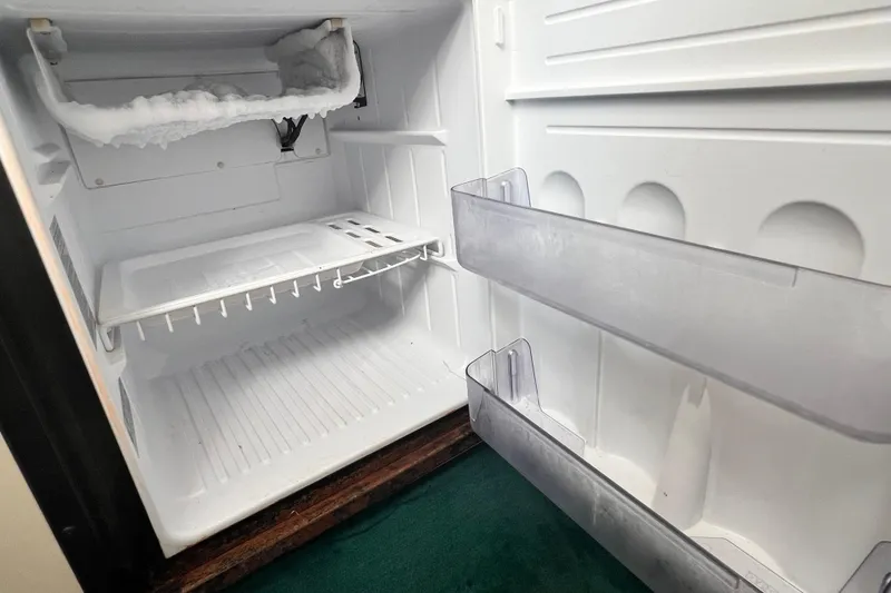 Slide: The Image of Empty refrigerator with frosted freezer in 1997 Sea Ray 270 Sundancer boat. - 15