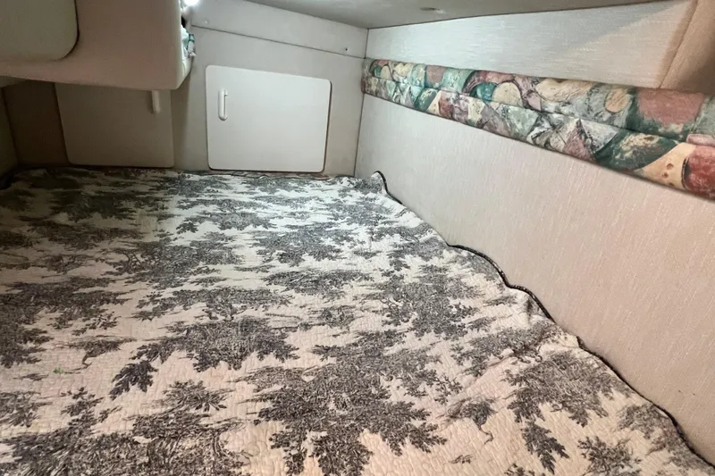 Slide: The Image of Interior cabin of 1997 Sea Ray 270 Sundancer with patterned bedding. - 16