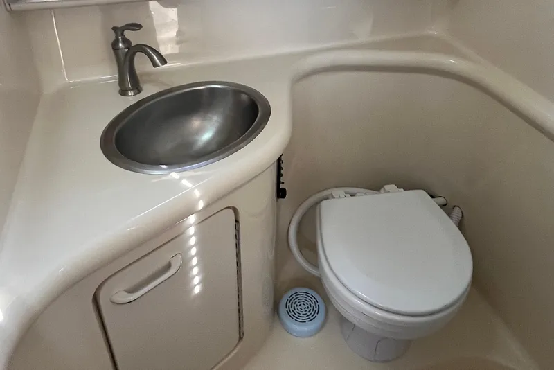 Slide: The Image of 1997 Sea Ray 270 Sundancer bathroom with sink and toilet. - 18
