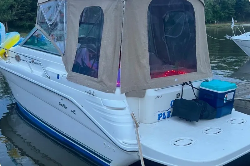Slide: The Image of 1997 Sea Ray 270 Sundancer boat docked with canopy and accessories. - 2