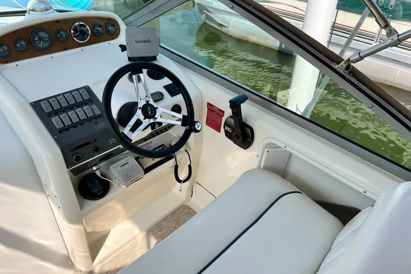 Slide: The Image of 1997 Sea Ray 270 Sundancer helm with Garmin GPS and classic steering wheel. - 6