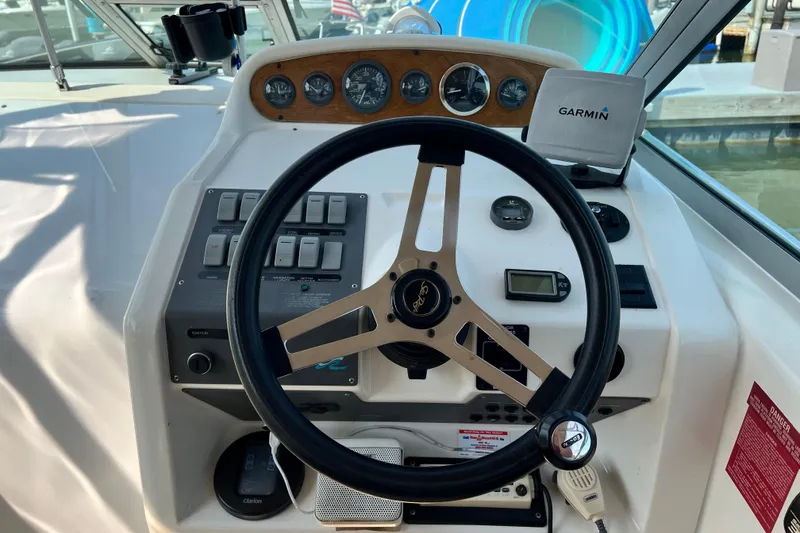 Slide: The Image of 1997 Sea Ray 270 Sundancer helm with steering wheel, gauges, and Garmin GPS. - 7