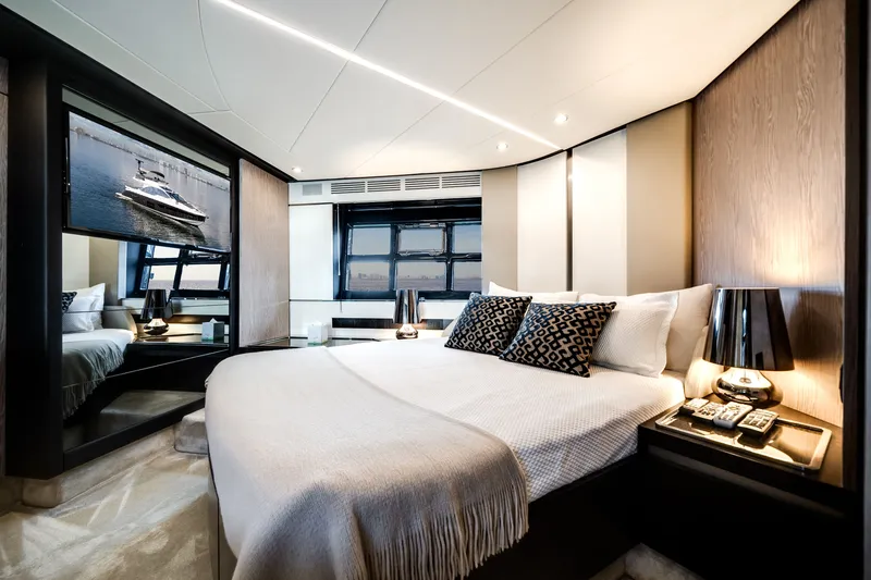 Slide: The Image of Luxurious cabin with a large bed, stylish pillows, and windows overlooking the water. - 47