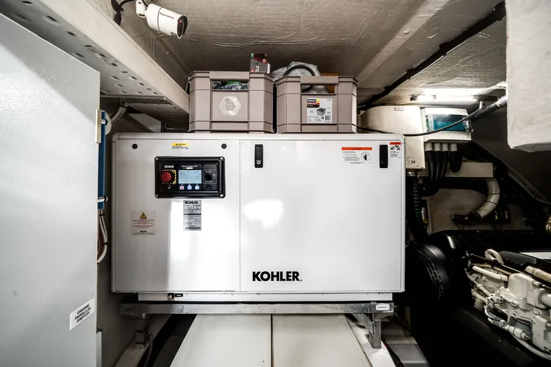 Slide: The Image of The engine room of a 2021 Azimut S6 featuring a Kohler generator. - 64